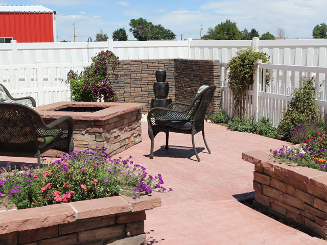 Vinyl alternating picket and vertical basketweave fencing with wood fire pit and planter septic tank covers
