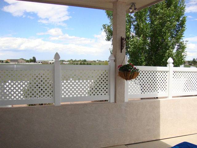 Vinyl lattice fencing on top of a stucco wall