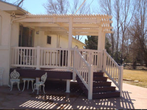 Composite deck with vinyl pergola and railing