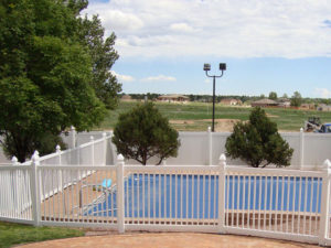 Four foot vinyl pool rail with solid privacy fencing