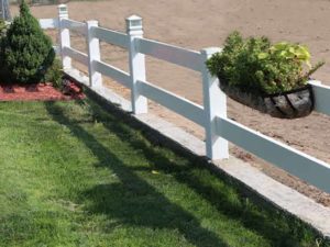Residential ranch rail fencing with post lights