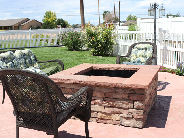 Wood burning fire pit with vinyl picket and semi-privacy fencing