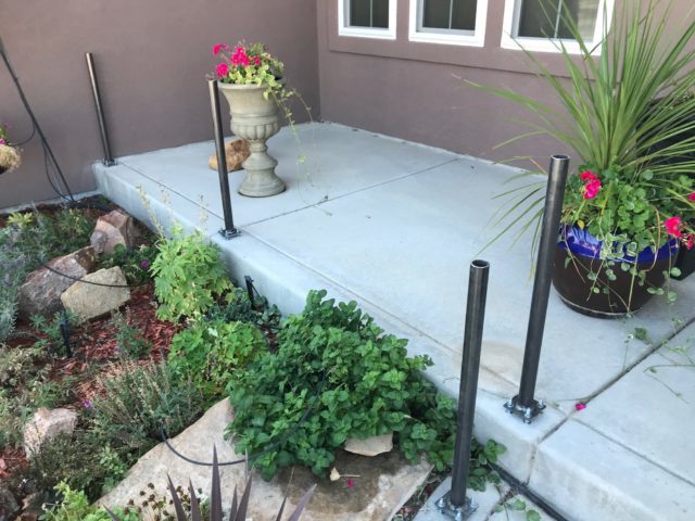 Vinyl railing with metal post supports