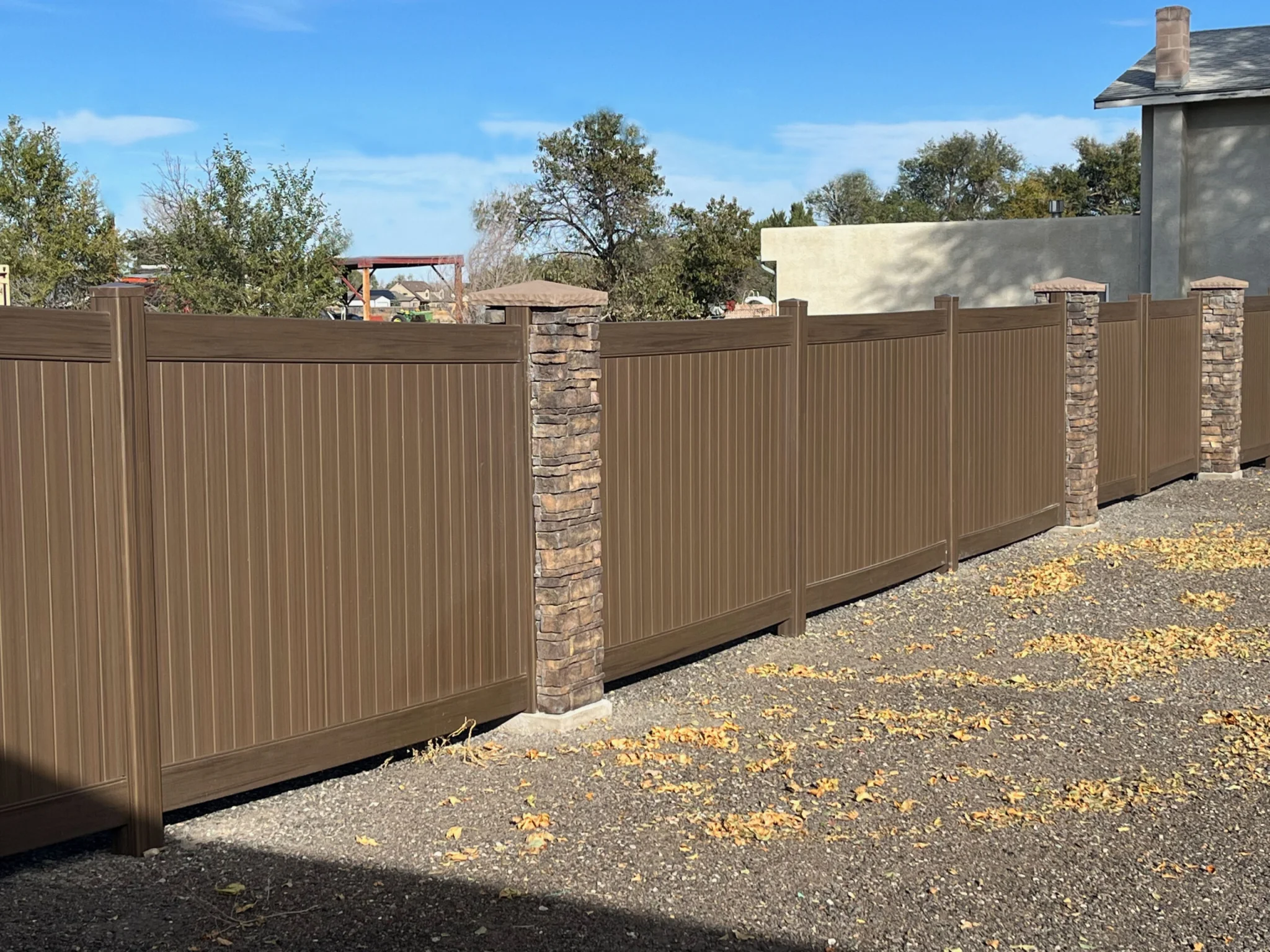 Ply Gem Woodland Select Chestnut Brown with stone pillars